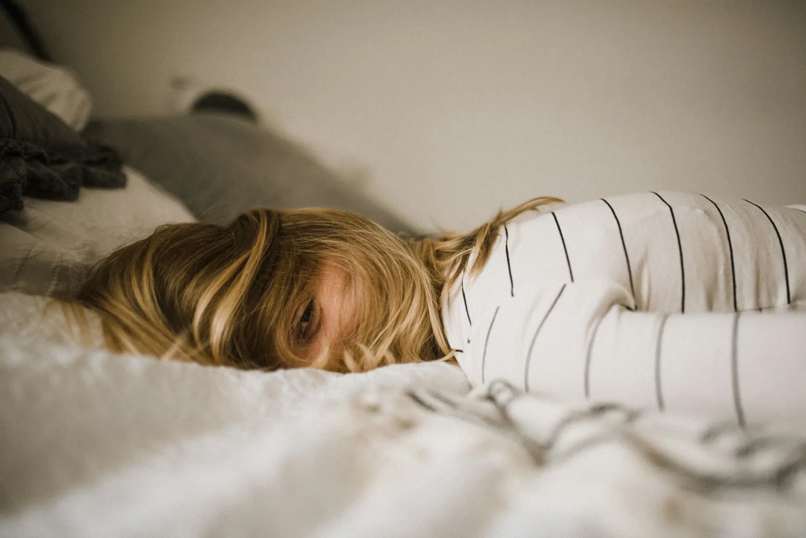 Smiling woman lying on her bed, representing hope and resilience during her fertility journey, encouraging others to seek support through counseling