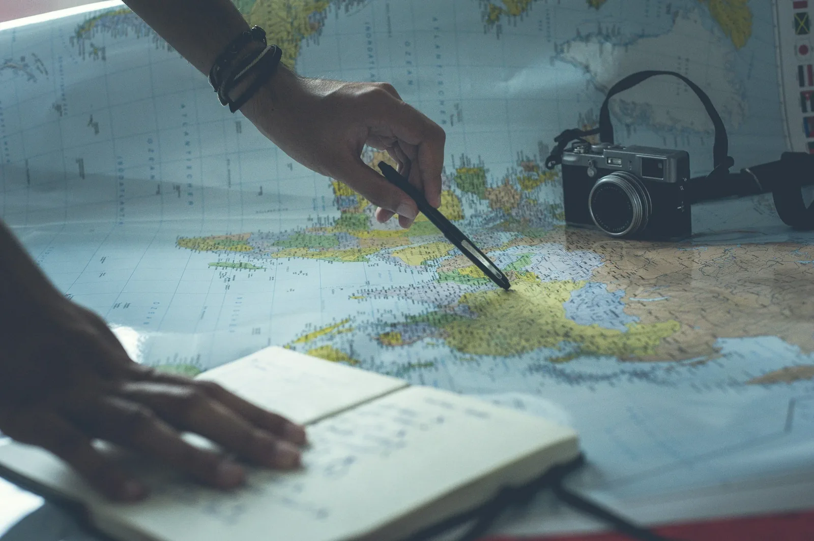 An image of a hand marking a new path on a map, symbolizing the process of reframing goals and creating a new, meaningful direction for the future